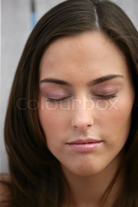 beautiful woman with her eyes closed stock image colourbox