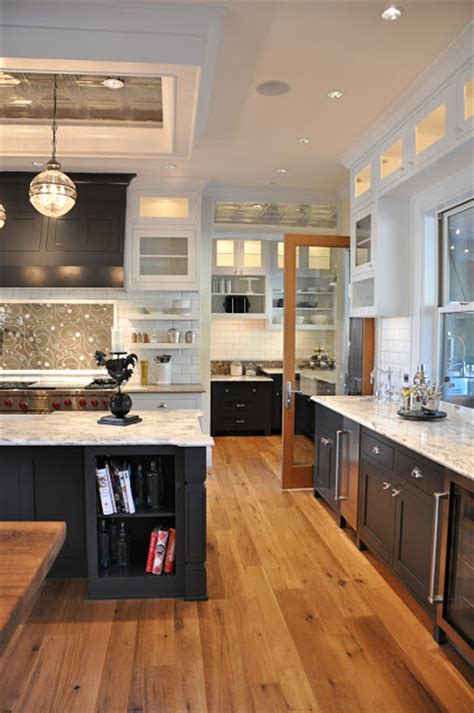 Love how this kitchen renovation creates an open feel for our clients to their dining room and office and a better transition to back yard! I like how this works - kitchen is white above with white countertops. Yet the black cabinets ...