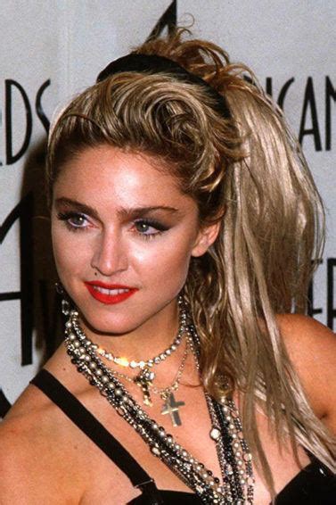 Madonna hairstyles in early 1980s were styled by adding a lot of volume and cutting bangs ta the right side. 11 Iconic Madonna Hairstyles from the 1980s,1990s to Now