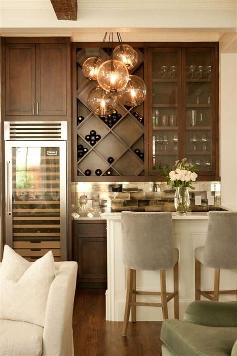 Many kitchen cabinets fall a few inches short of the ceiling, so that's wasted space right there. Chic living room bar features dark stained shaker cabinets ...