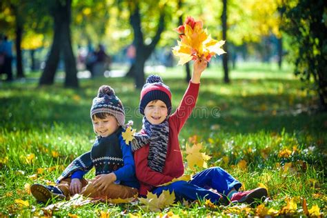 Happy Children Playing In Beautiful Autumn Park On Warm Sunny Fall Day
