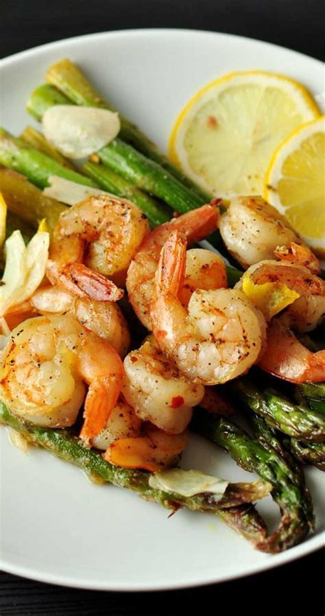 Divide 1 pound trimmed asparagus and 6 tablespoons cubed unsalted butter between the packets. Lemon and Garlic Shrimp Over Asparagus Recipe - Flavorite