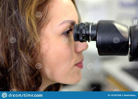 Young Pretty Woman Ophthalmologist Optometrist Optician Examins Visual Acuity of a Patient ...