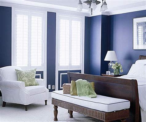 Navy and beige bedroom features walls painted navy blue lined with a beige nailhead bed dressed in white and grey bedding blanked by espresso nightstands illuminated. From Navy To Aqua: Summer Time Decor In Shades Of Blue ...