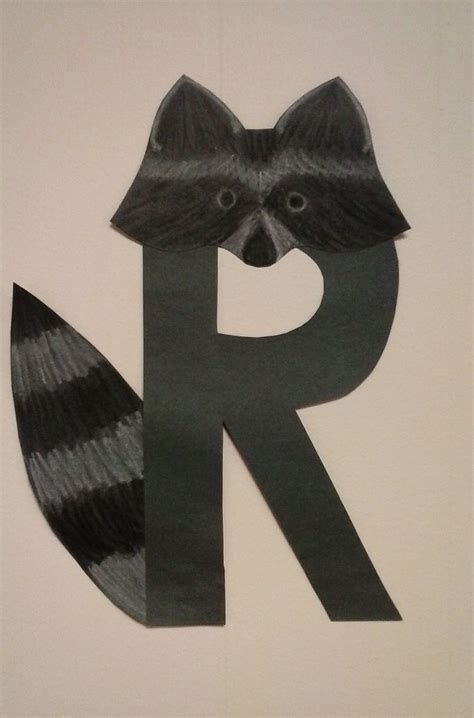 The Letter R Is Made Out Of Paper With A Raccoon On It