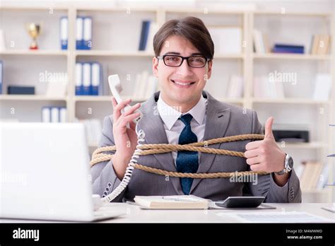Businessman Tied Up With Rope In Office Stock Photo Alamy