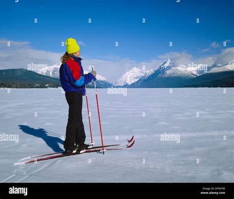 Cross Country Skiers On Frozen Lake Mcdonald In Winterglacier National
