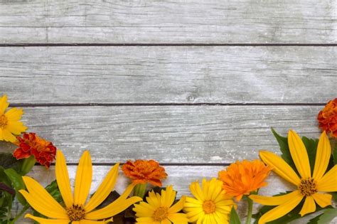 Premium Photo Flowers On A Wooden Background
