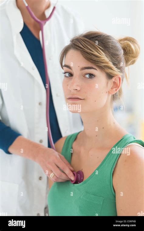 Doctor Examining A Female Patient With A Stethoscope Stock Photo Alamy
