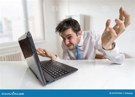 Young Confused Man Is Working With Laptop Stock Photo Image Of
