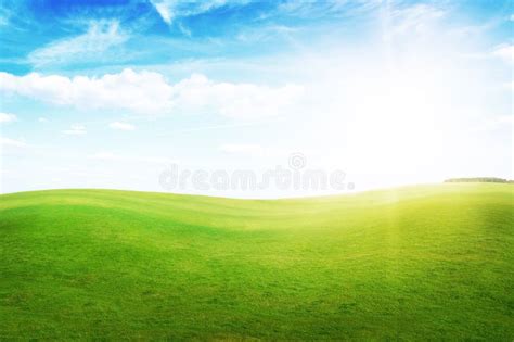 Green Grass Hills Under Midday Sun In Blue Sky Stock Photo Image Of