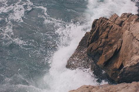 Photo Of Waves Crashing Against Rocks