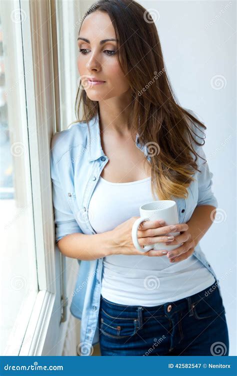 Beautiful Woman Drinking Coffee In The Morning Near The Window Stock