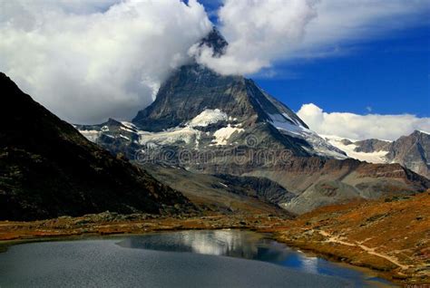 A Mountain Matterhorn View Reflected In The Smooth Surface Of The Lake