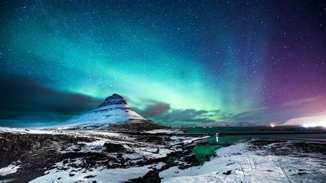 Northern Lights At Mount Kirkjufell With A Man Passing By Iceland