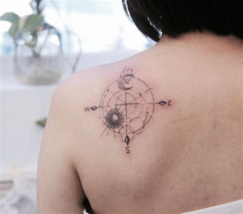 A Woman With A Compass Tattoo On Her Back