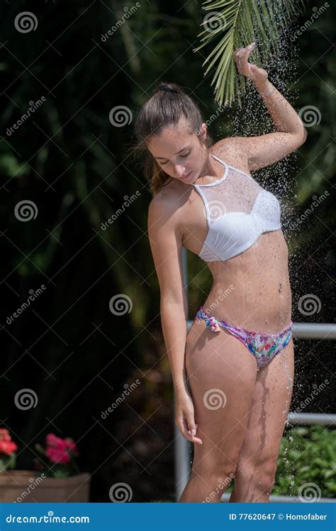Girl Wear Bikini Standing Under The Outdoor Pool Shower Stock Image