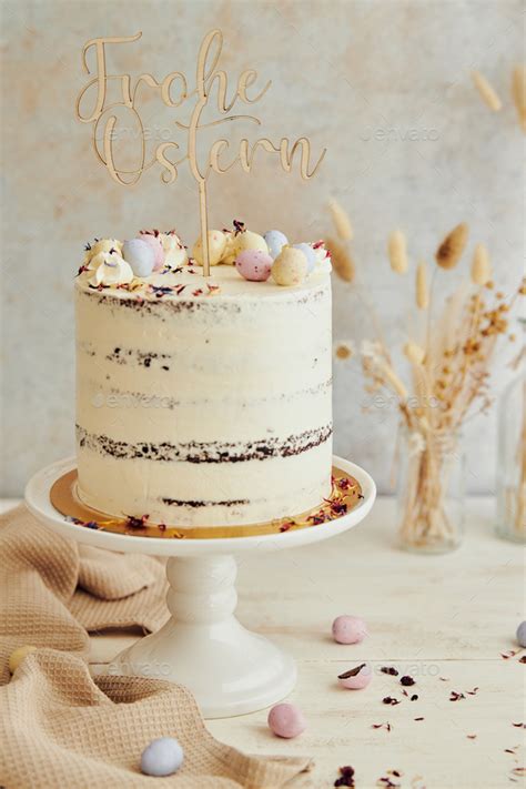 Vertical Shot Of A Delicious Happy Easter Frohe Ostern Naked Cake On A White Table Stock Photo
