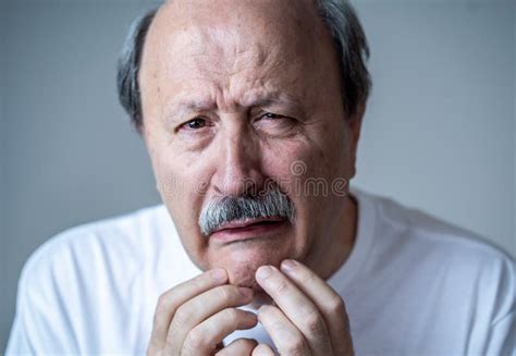 Portrait Of Older Adult Man With Sad And Worried Expression Suffering