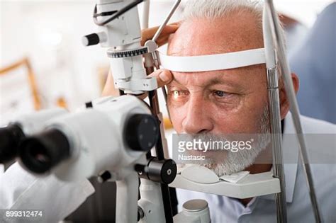 Senior Man Doing Eye Test With Optometrist High Res Stock Photo Getty
