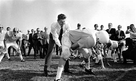 Posterazzi Ronald Reagan Playing Football Photo Print 30 X 24