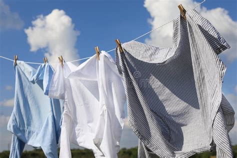 Clean Clothes Hanging On Washing Line Against Sky Drying Laundry Stock