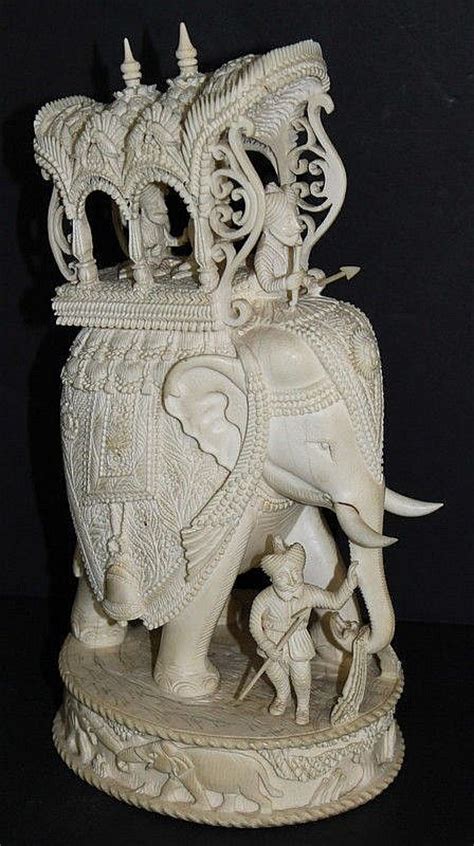 An Elephant Statue Sitting On Top Of A Table
