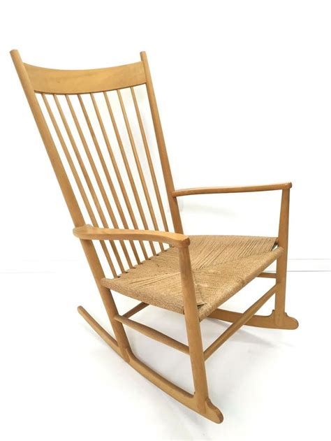 A Wooden Rocking Chair Sitting On Top Of A White Floor