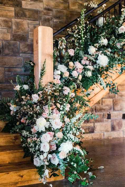 Flowers And Greenery Are Arranged On The Stairs At This Wedding Venue