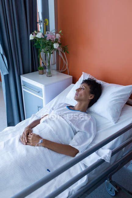 High Angle View Of Middle Aged Mixed Race Female Patient Sleeping In