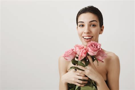 Free Photo Happy Woman Standing Naked With Bouquet Of Roses Smiling Flattered
