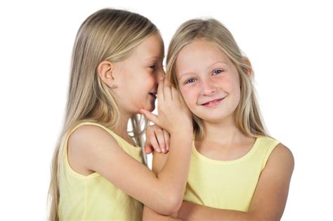 Premium Photo Blonde Girl Whispering To Her Sister