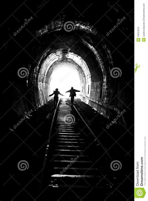 Man And Woman Walking Towards The Light Stock Image