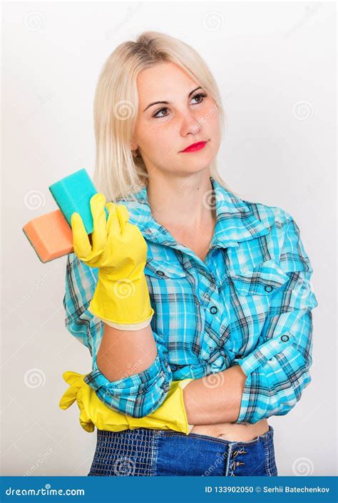 Thoughtful Blonde Housekeeper Demonstrate Sponges For Washing Stock