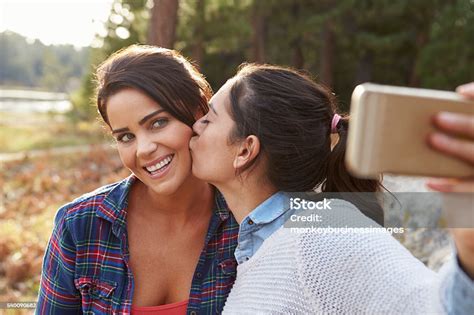 Lesbian Couple In The Countryside Kiss And Take A Selfie Stock Photo