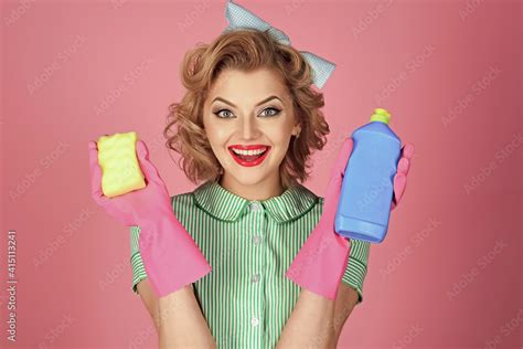 Sexy Smiling Housekeeper In Uniform With Clean Spray Sponge Pinup