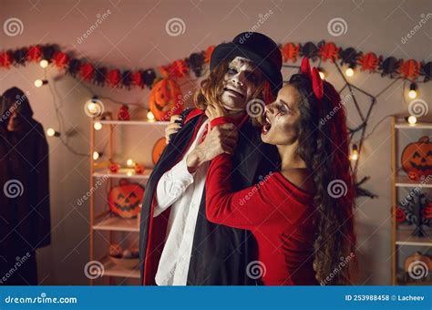 Devil Woman Having Fun And Jokingly Choking Scared Vampire At Spooky