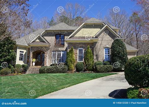 Street View Of A Suburban House With Stone Exterior In An Affluent