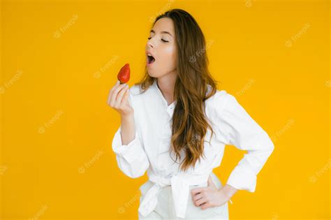 Premium Photo Sexy Woman Eating Strawberry Sensual Red Lips Red Manicure And Natural Lipstick
