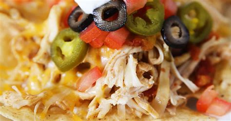 Add chopped onions, garlic, chicken, seasoning, along with water and guajillo peppers in a crock pot. Slow Cooker Shredded Chicken Nachos Recipe | Skip To My Lou