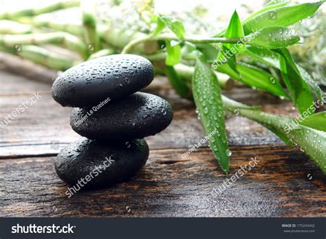 Wet Black Smooth Polished Hot Massage Stones With Water Drops And Droplets In Zen Style Soothing