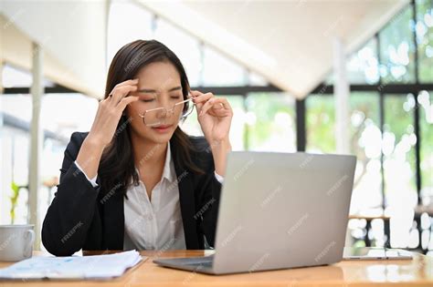 Premium Photo Exhausted Asian Businesswoman Taking Off Her Eyeglasses