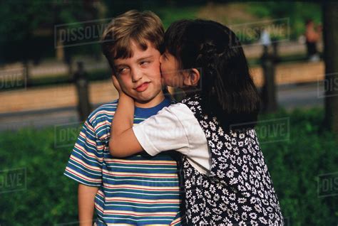 Girl Kissing Reluctant Boy Stock Photo Dissolve