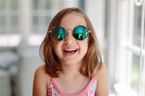 Cute Young Girl With Sunglasses Laughing By Stocksy Contributor Jakob Lagerstedt Stocksy