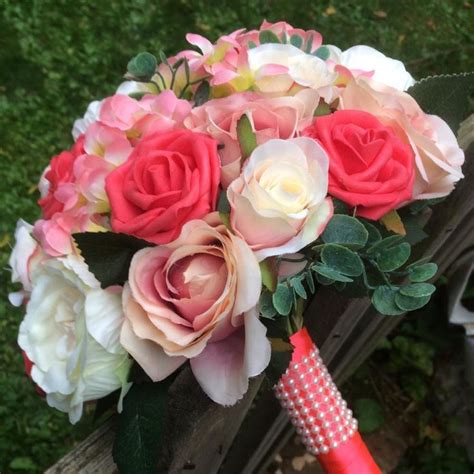 A Brides Bouquet Featuring Apricot Coral And Peach Roses And Hydrangea
