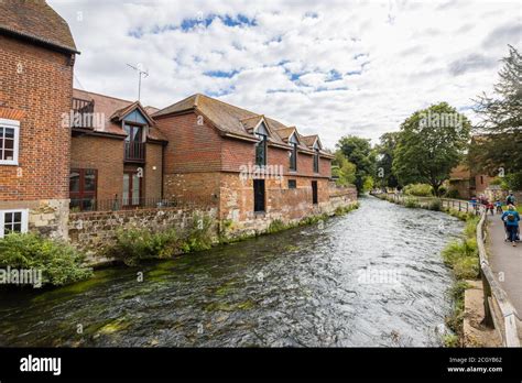 The River Itchen Flowing Through Past Historic Riverside Buildings At