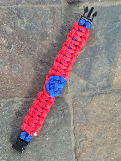 The cross is formed by creating one section with 3 snake knots and a loop that will serve as the top part of the cross. Red Paracord - cobra stitch on blue paracord with Celtic Heart Knot #TritonParacord # ...