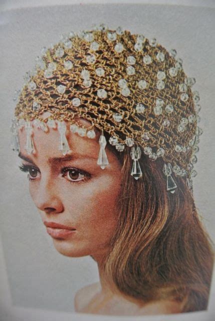 A Woman Wearing A Head Piece Made Out Of Beads