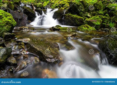 Stream Cascading Over Rocks With A Waterfall Stock Image Image Of