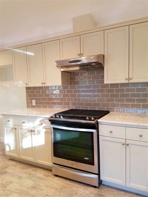It provides a strong contrast against the silver hue and helps the appliances stand out. Marble countertops. Gray subway tile,Stainless steel appliances all working well in this kitchen ...